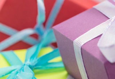 Green, red, and purple gift boxes; highlighting charitable donations and taxes