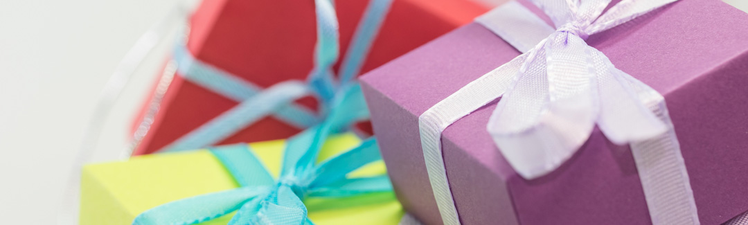 Green, red, and purple gift boxes; highlighting charitable donations and taxes