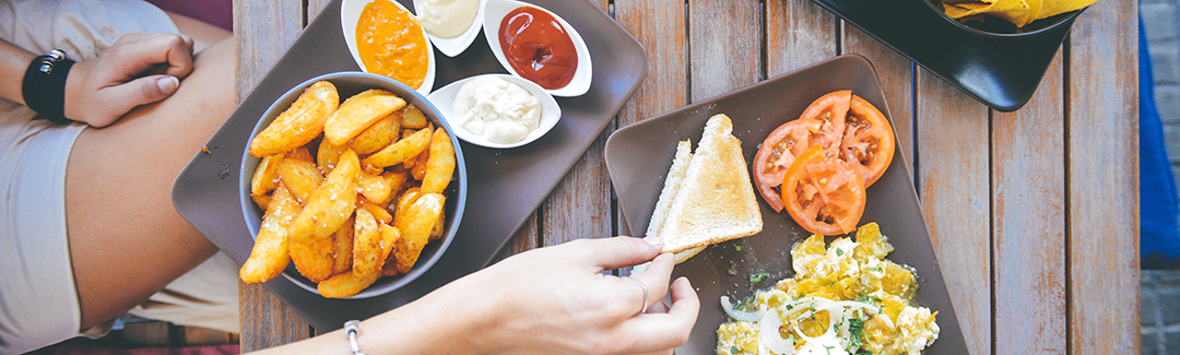 Top view of three plates with food; highlighting tax preparation for meal expenses