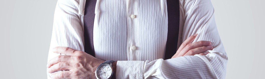 Closeup of a single man with arms crossed wearing a shirt, suspenders, and bow-tie; highlighting a personal services corporation