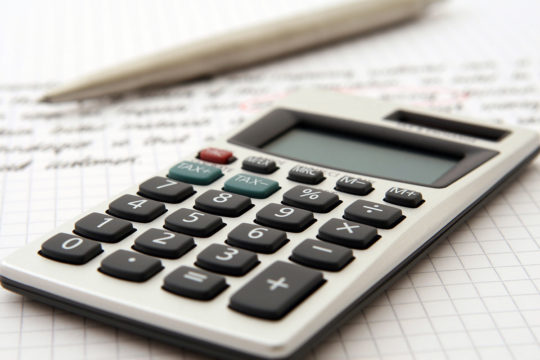 Calculator and notepad highlighting tax free savings accounts